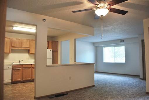 A room with a ceiling fan and a window.