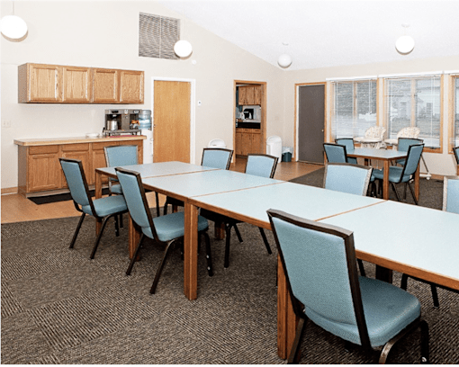 A conference room with a long table and chairs.