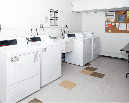 A laundry room with washers and dryers.