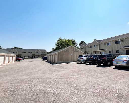 A parking lot with cars and buildings in the background.