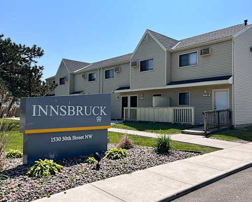 A sign for Innsbruck is in front of a building.