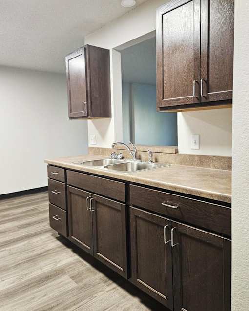 A kitchen with brown cabinets and a counter top.