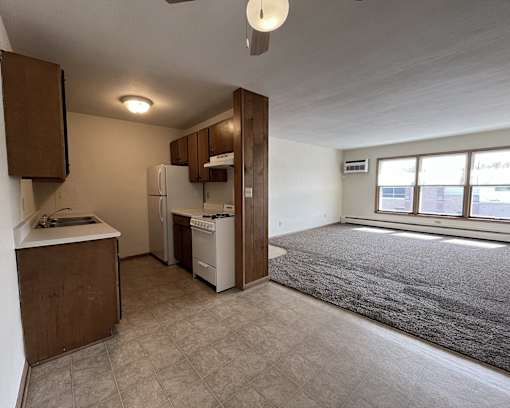 an empty kitchen and living room in an empty apartment