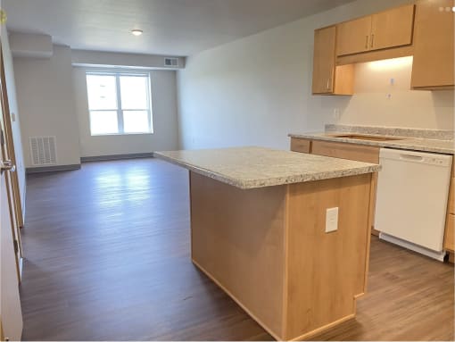 an empty kitchen with an island in the middle