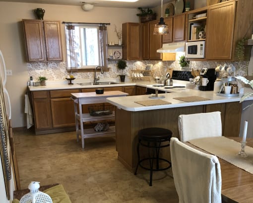 a kitchen with wooden cabinets and a white counter top
