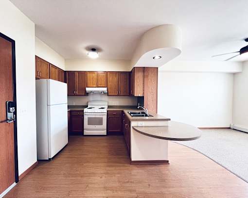 A kitchen with a white refrigerator and a white stove.