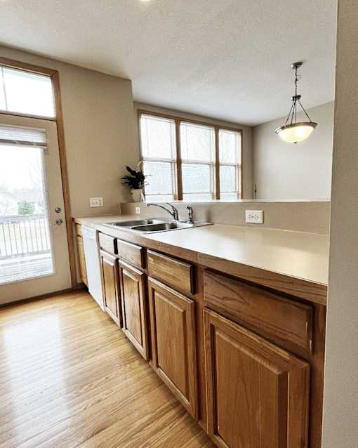 A kitchen with wooden cabinets and a white countertop.