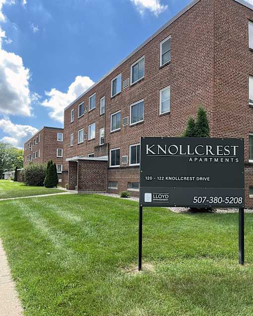 Knollcrest Apartments is a brick building with a sign in front.