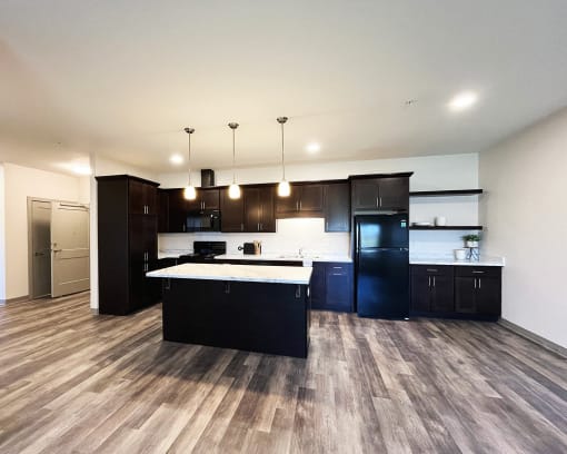 a large kitchen with black appliances and a white counter top