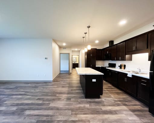 an empty kitchen with a large island in the middle