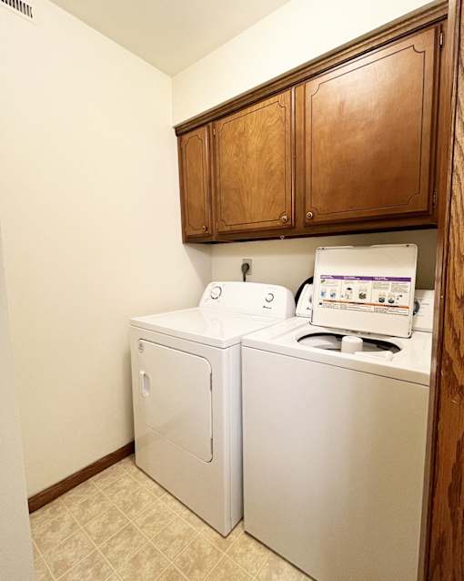 A small laundry room with a washer and dryer.