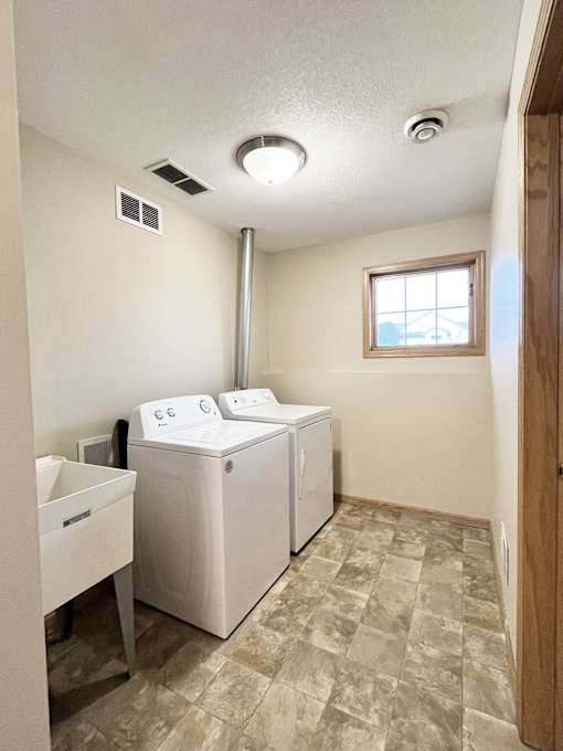A small bathroom with a washer and dryer.