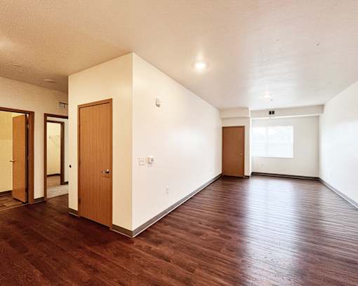 A room with wooden floors and white walls.