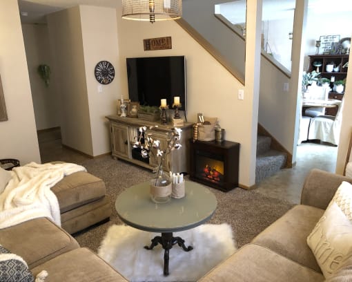 a living room with a tv and couches