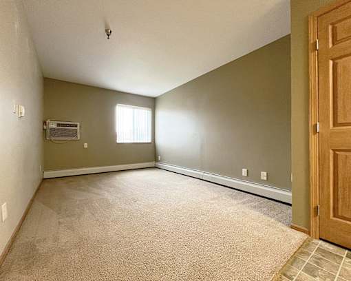 an empty room with a door and a window