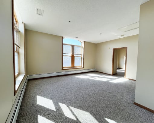 an empty room with a window and a door