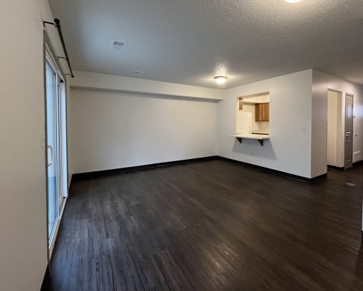 the living room and kitchen of an empty apartment