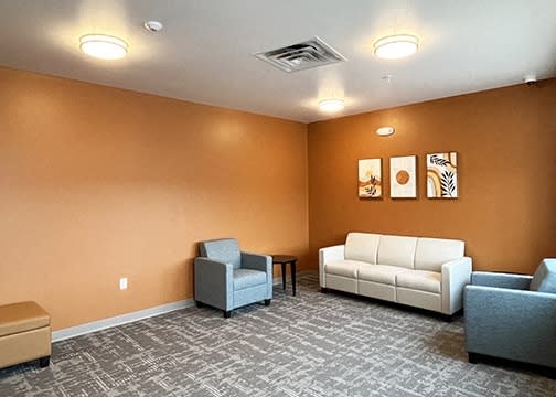 a living room with couches and chairs and a table