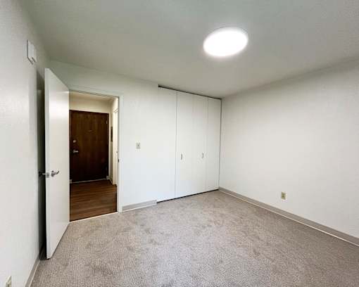 A room with a carpeted floor and white walls.