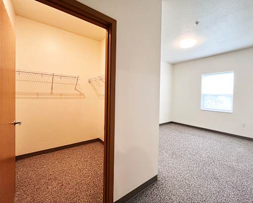A small, empty room with a doorway leading to another room.
