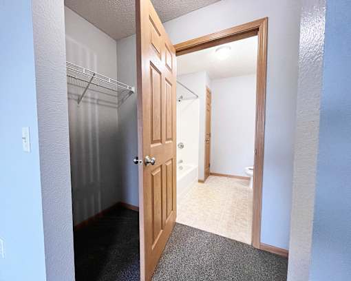 A small room with a door and a closet.