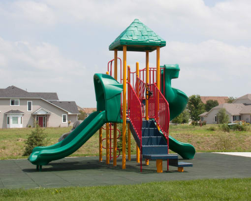 a playground with a slide in a park