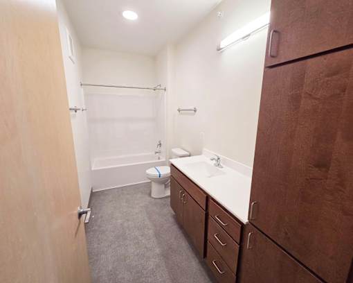 A bathroom with a toilet, sink, and bathtub.