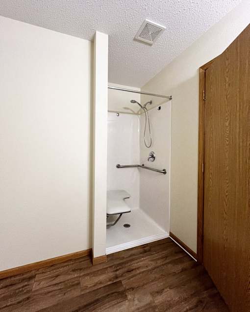 A small bathroom with a walk in shower.