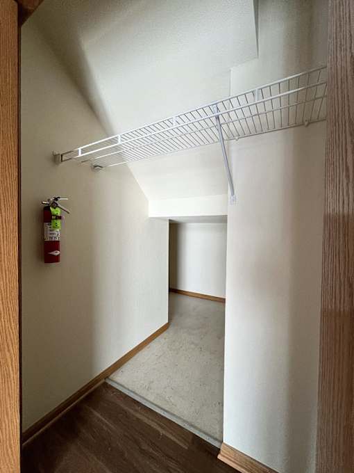 a walk in closet with a fire hydrant on the wall
