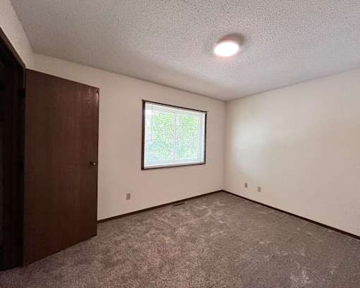 A room with a window and a door.