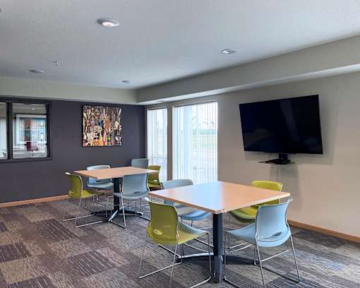 A conference room with a large table and chairs.