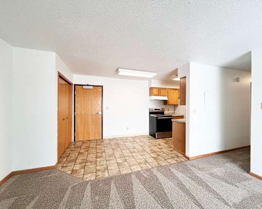 A kitchen area with a sink and a refrigerator.