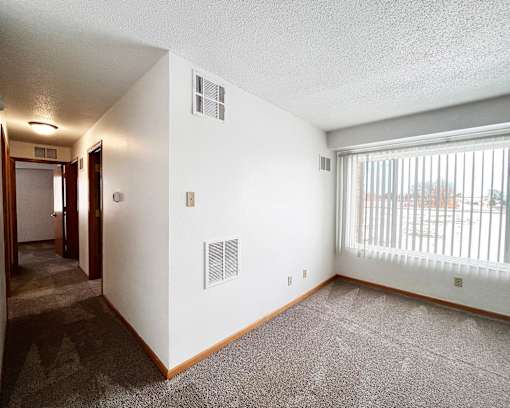 A room with a window and a door.