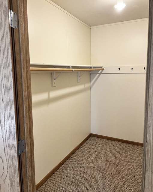 an empty room with a closet and a door open