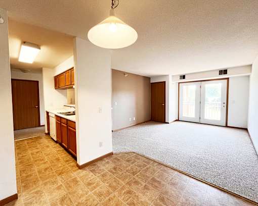 A kitchen area with a counter and cabinets is visible.