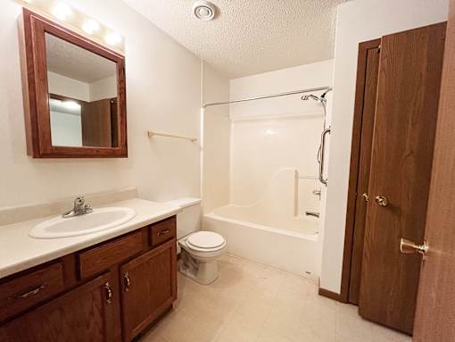A bathroom with a sink, toilet, and bathtub.