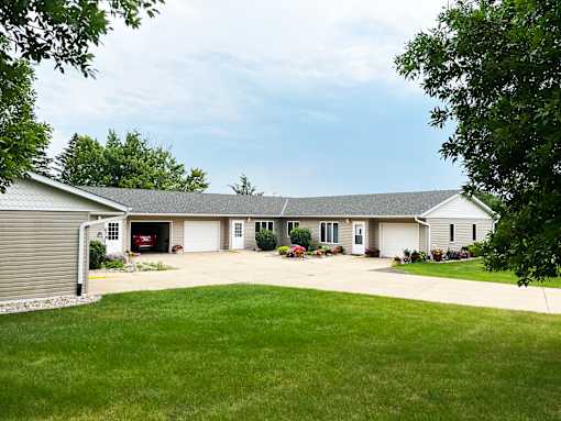 A house with a grey roof and a garage door.