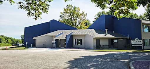 A large blue building with a sign that says "Windemere" in front of it.