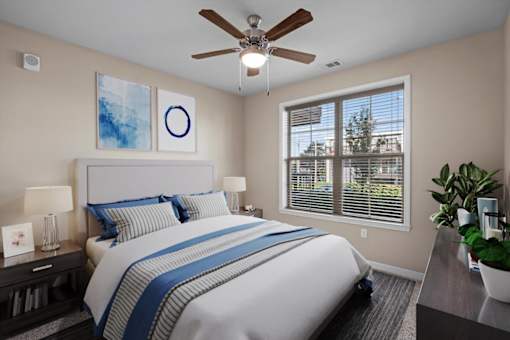 a bedroom with a large bed and a ceiling fan at The Dorset, Kansas City, Missouri