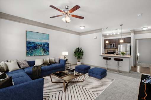 a living room with a blue couch and a coffee table at Stonepost Crossing Apartments, Kansas, 66213