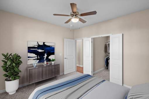 a bedroom with a large bed and a ceiling fan at The Dorset, Kansas City, 64112