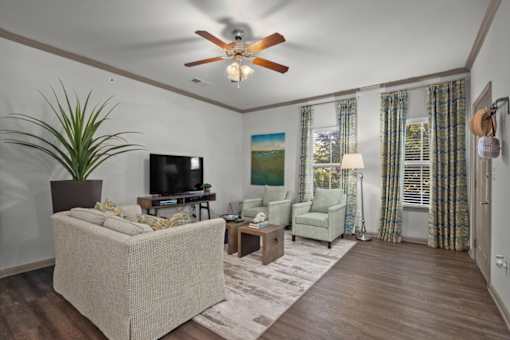 a living room with a ceiling fan and couches at Stonepost Crossing Apartments, Overland Park, KS