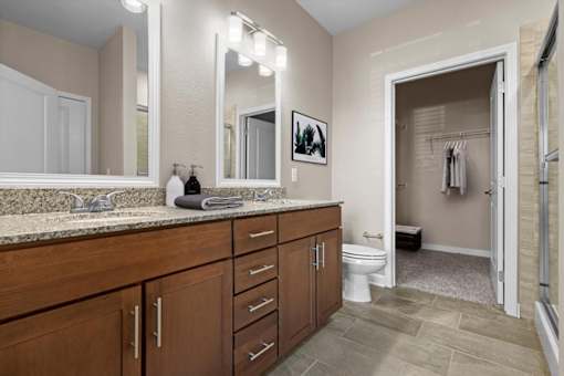 a bathroom with a large vanity and a walk in shower at The Dorset, Kansas City, Missouri
