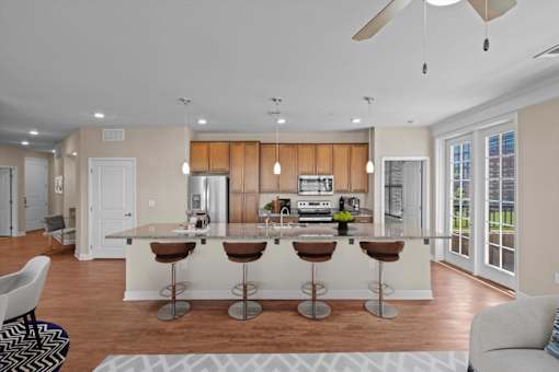 a kitchen and living room with a large island at The Dorset, Kansas City, 64112