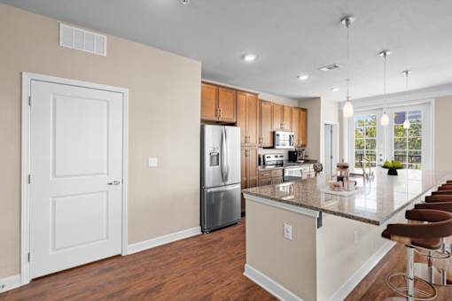 a kitchen with a large island and stainless steel appliances at The Dorset, Kansas City, 64112