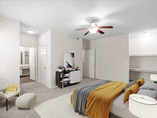 A large master bedroom with a ceiling fan, built-in shelving, bedroom closet and attached master bathroom. at Crescent Apartment Homes, Lenexa, KS, 66219