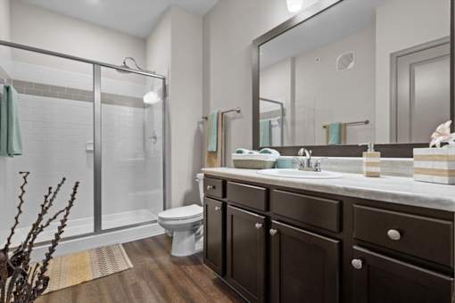 a bathroom with a toilet sink and shower at Stonepost Crossing Apartments, Overland Park, Kansas