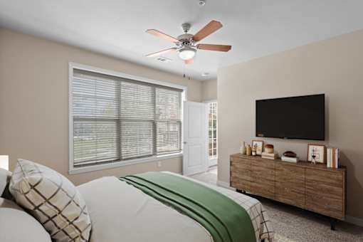 a bedroom with a large window and a ceiling fan at The Dorset, Kansas City, Missouri