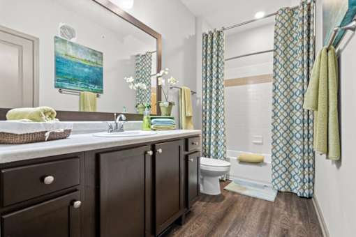 a bathroom with a sink toilet and shower at Stonepost Crossing Apartments, Overland Park, 66213