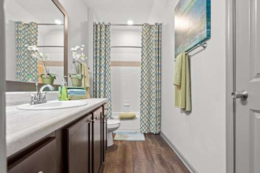 a bathroom with a toilet sink and shower at Stonepost Crossing Apartments, Kansas, 66213